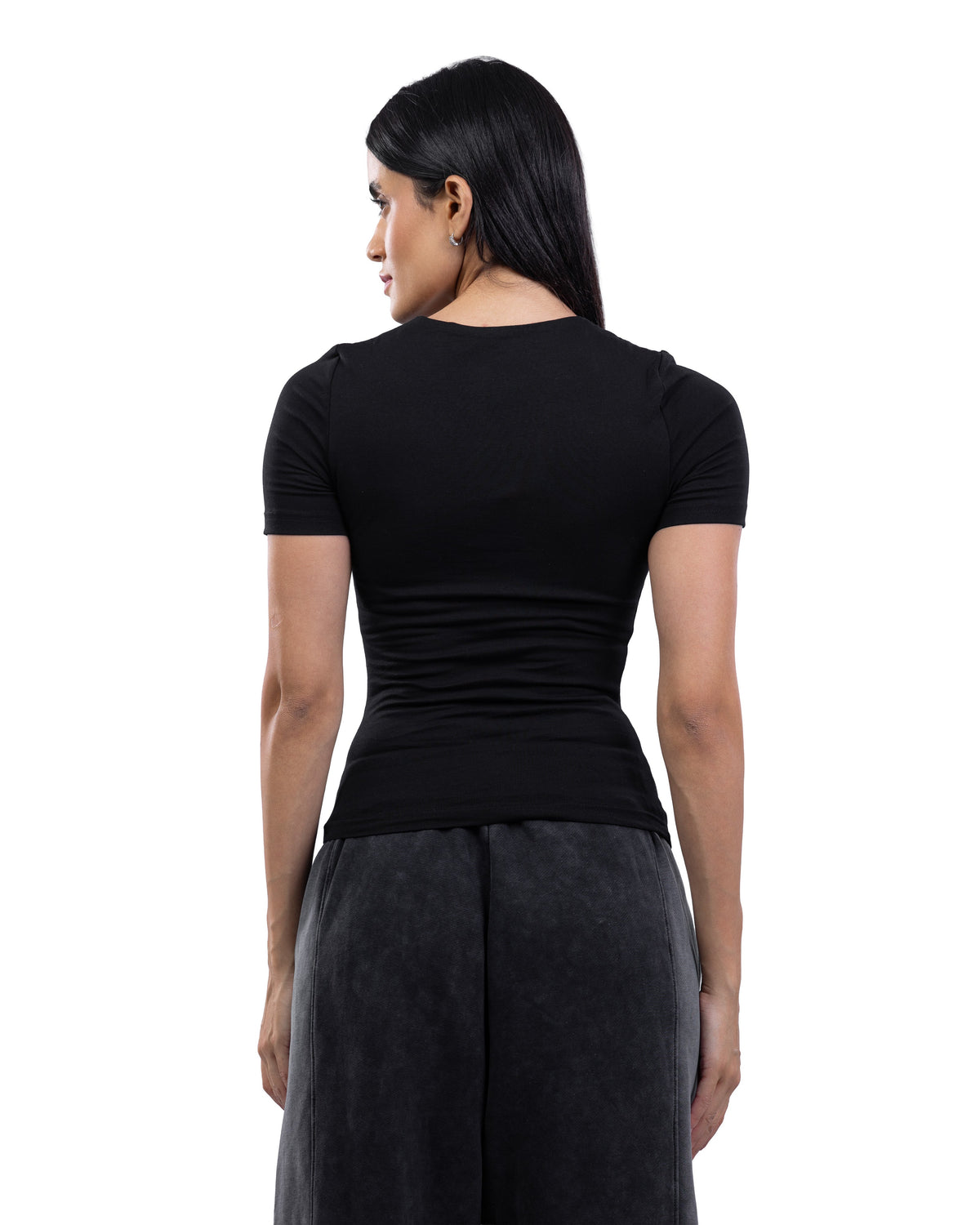 A woman shown from the back wearing a fitted black short-sleeve top and dark gray wide-leg pants against a plain white studio background.