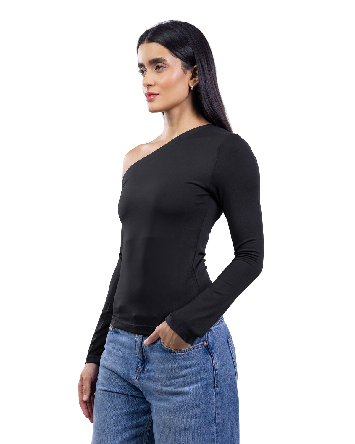 A woman modeling a black long-sleeve one-shoulder top paired with blue jeans against a plain white background.