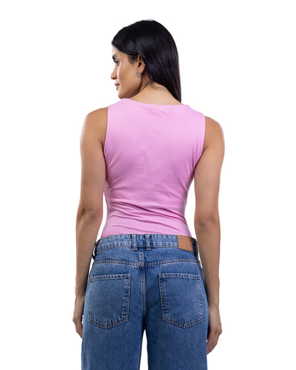 A woman shown from the back wearing a sleeveless pink top and blue jeans against a plain white background.