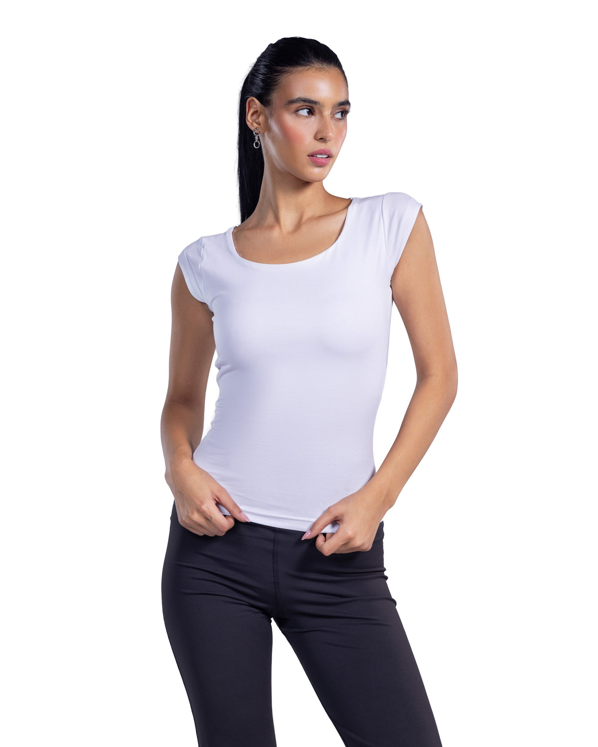 A woman modeling a white scoop-neck sleeveless top with cap sleeves, paired with black pants, against a plain white background.