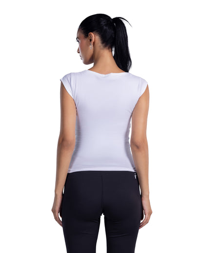 A woman shown from the back wearing a fitted sleeveless white top and black leggings against a plain white studio background.