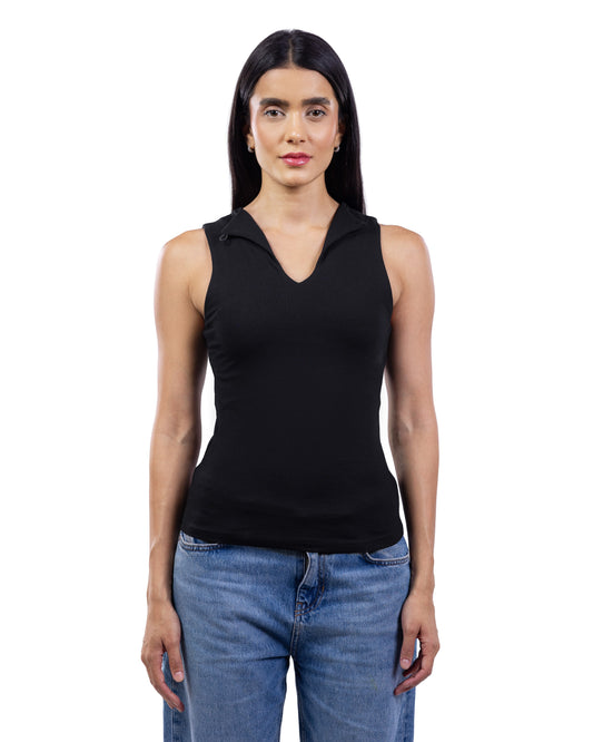 A woman modeling a black sleeveless knit top with a V-neck and a small collar detail, paired with blue jeans, against a plain white background.