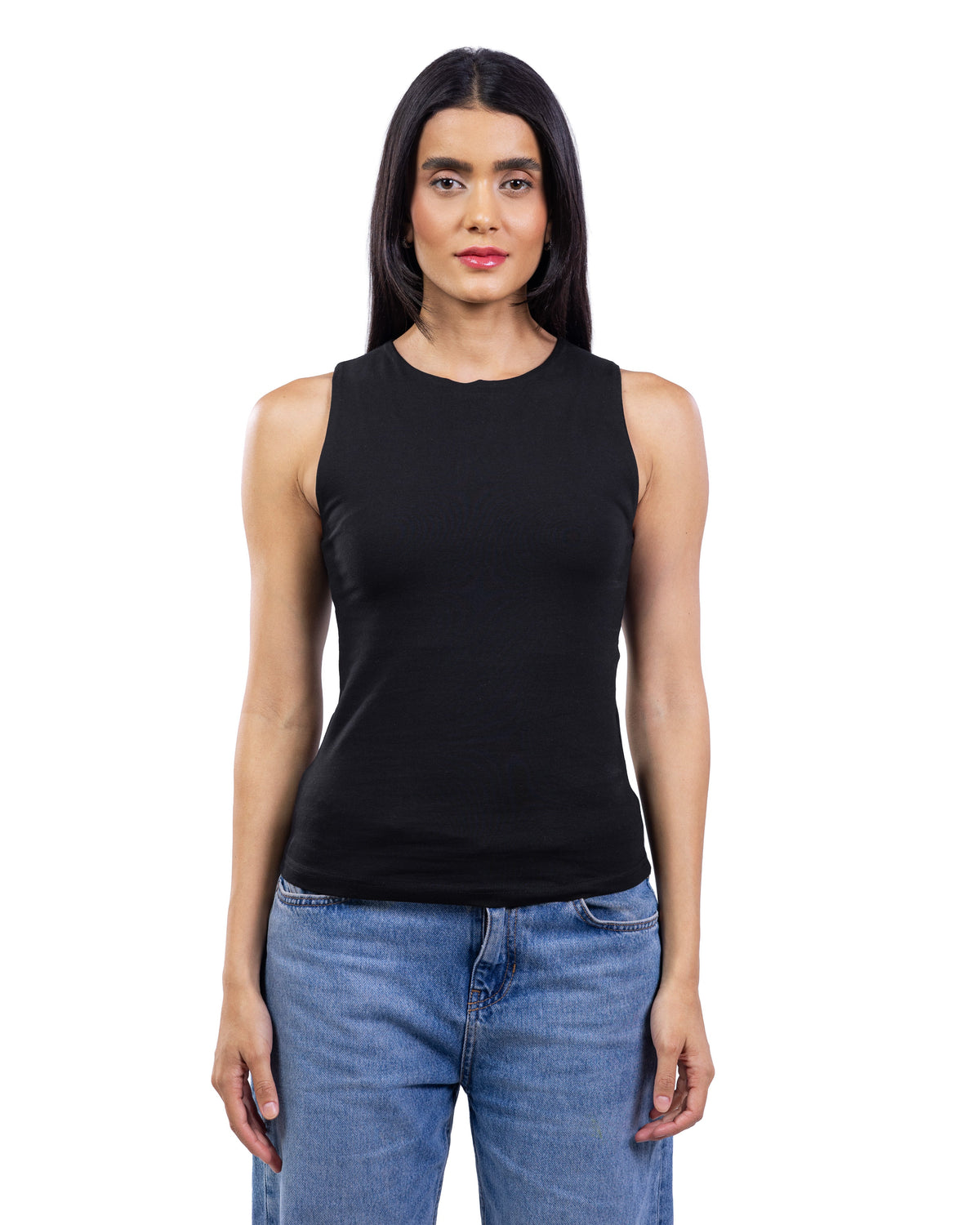 A woman modeling a sleeveless black tank top with a crew neck, paired with blue jeans, against a plain white background.